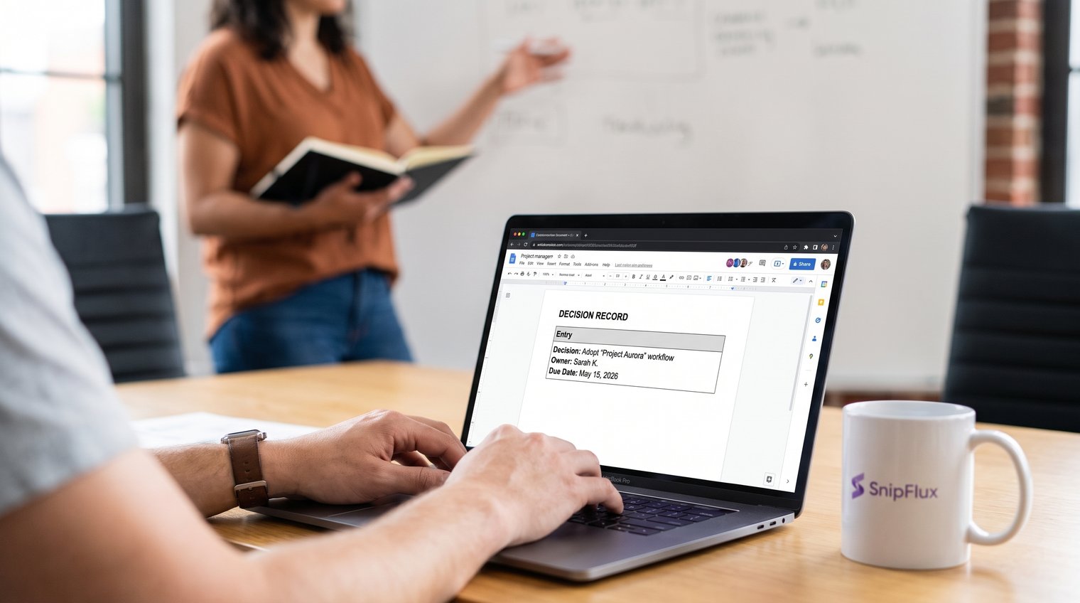 A project manager turning a team discussion into a concise decision record, with a clear owner and due date visible on a shared workspace