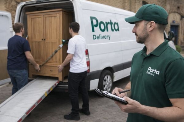A driver loading furniture into a van for eBay collection delivery