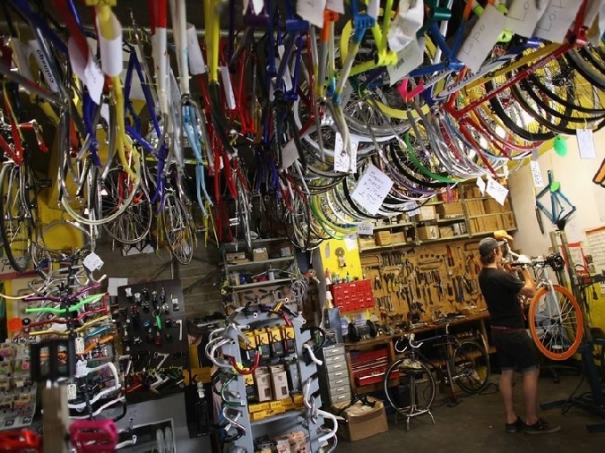 Busy London bike shop preps bikes for secure courier transport.