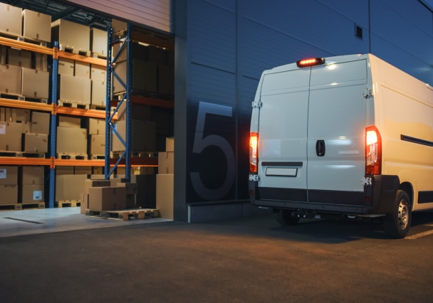 Delivery van at warehouse dock, showcasing efficient and reliable courier services.