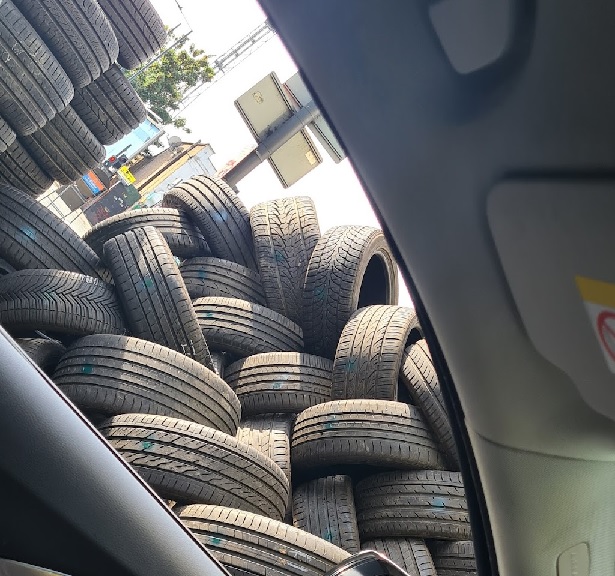 Stacks of tyres ready for transport, highlighting the need for a reliable courier service specialised in tyre delivery.